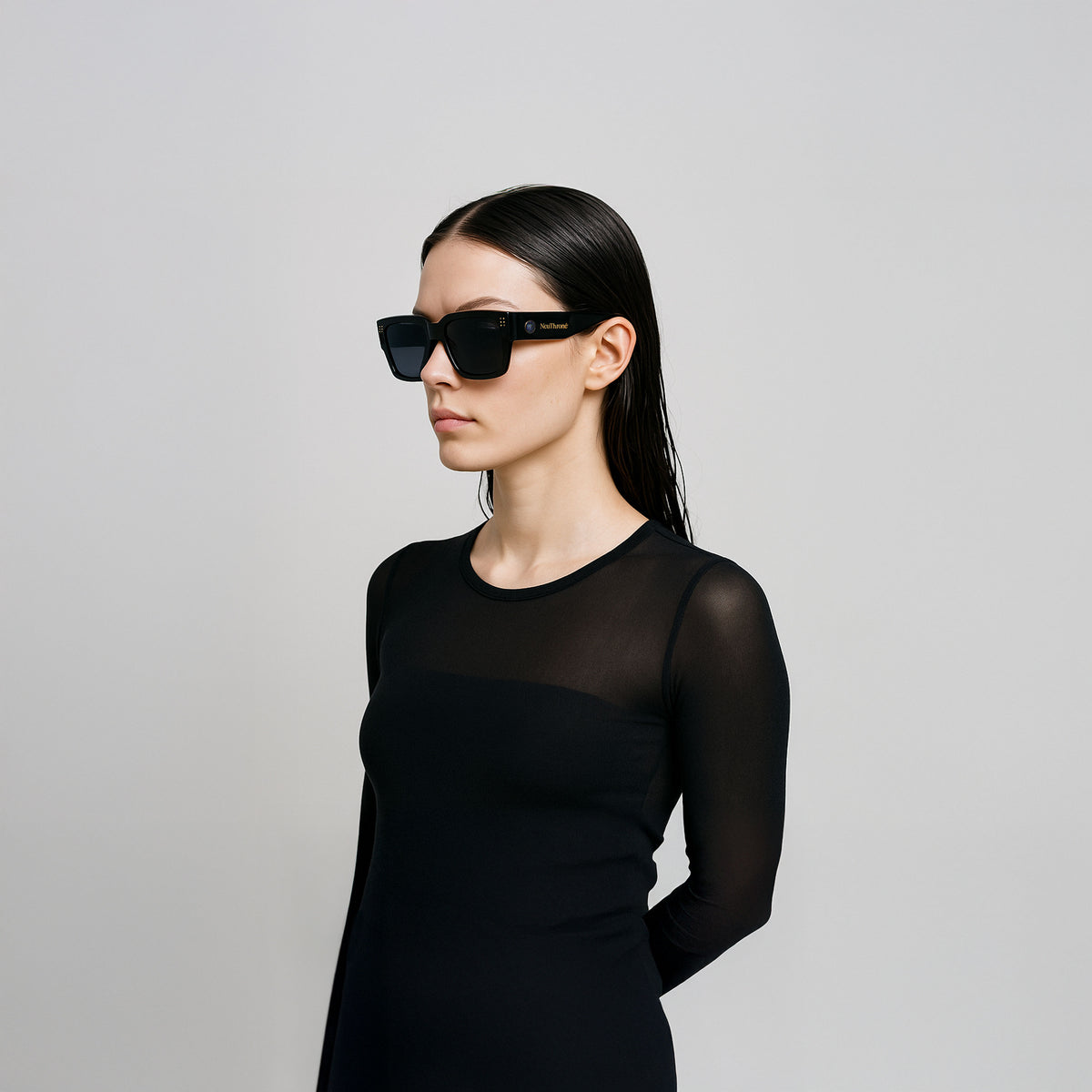 Model wearing black rectangular NeuThrone sunglasses, shown in a three-quarter view.